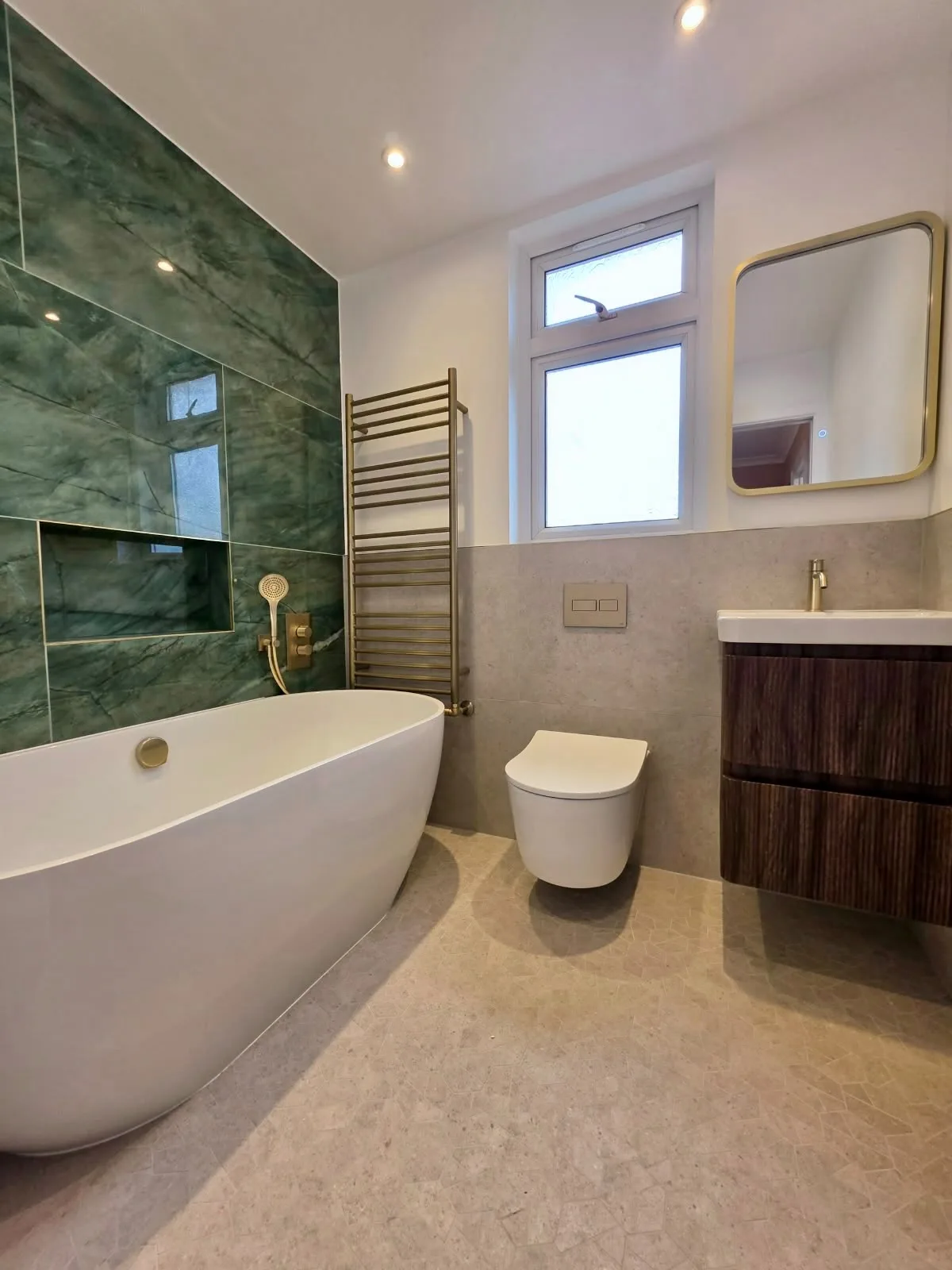 Modern bathroom with green marble accent wall