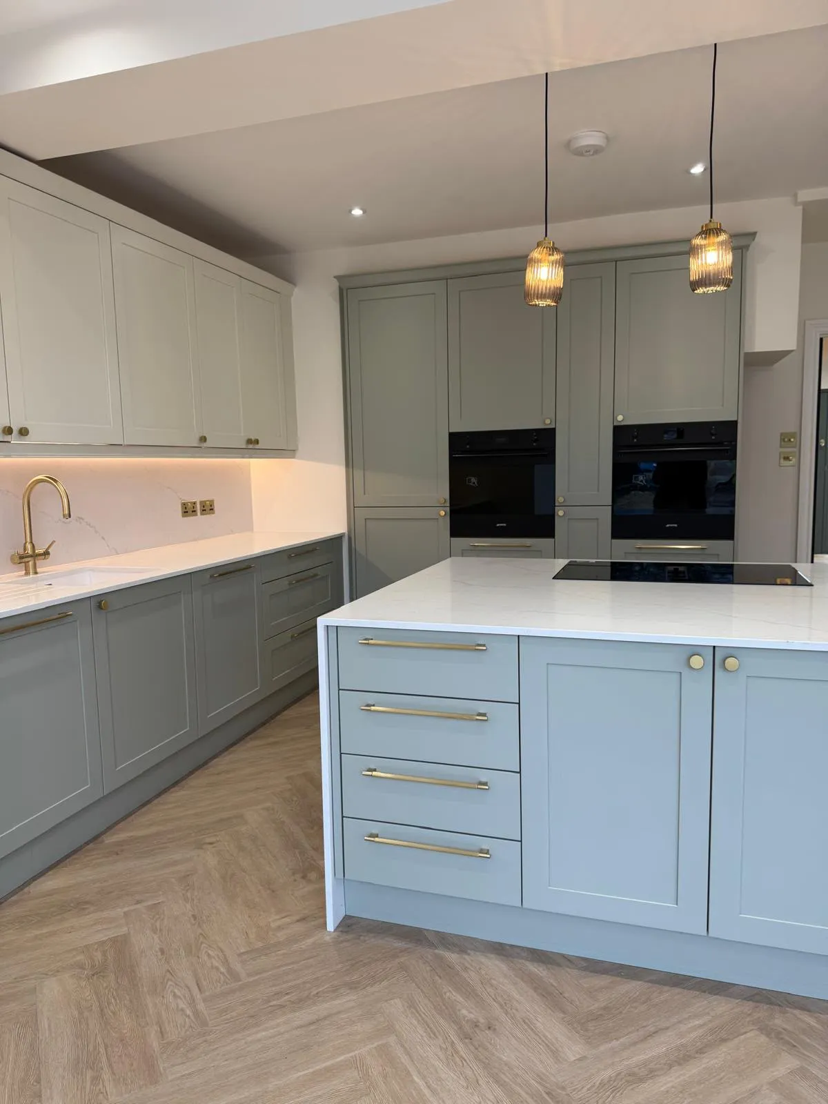 Shaker kitchen with island, built-in ovens and pendant lights