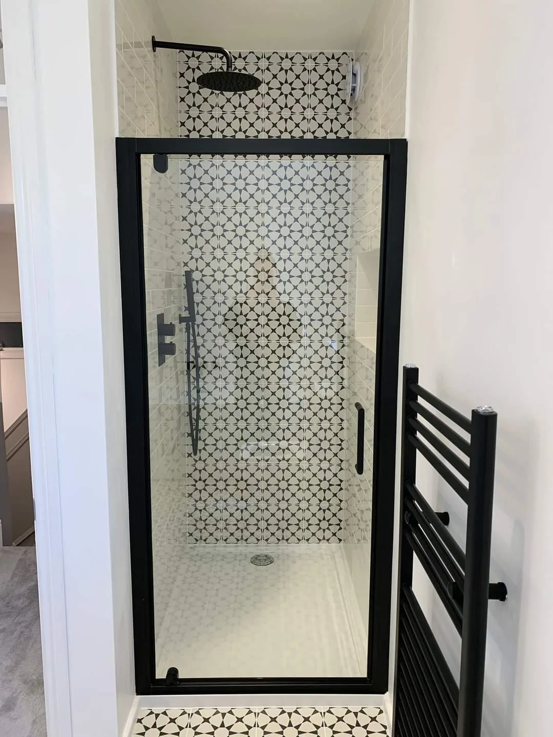Modern bathroom renovation showcasing a stylish shower enclosure with patterned tiles