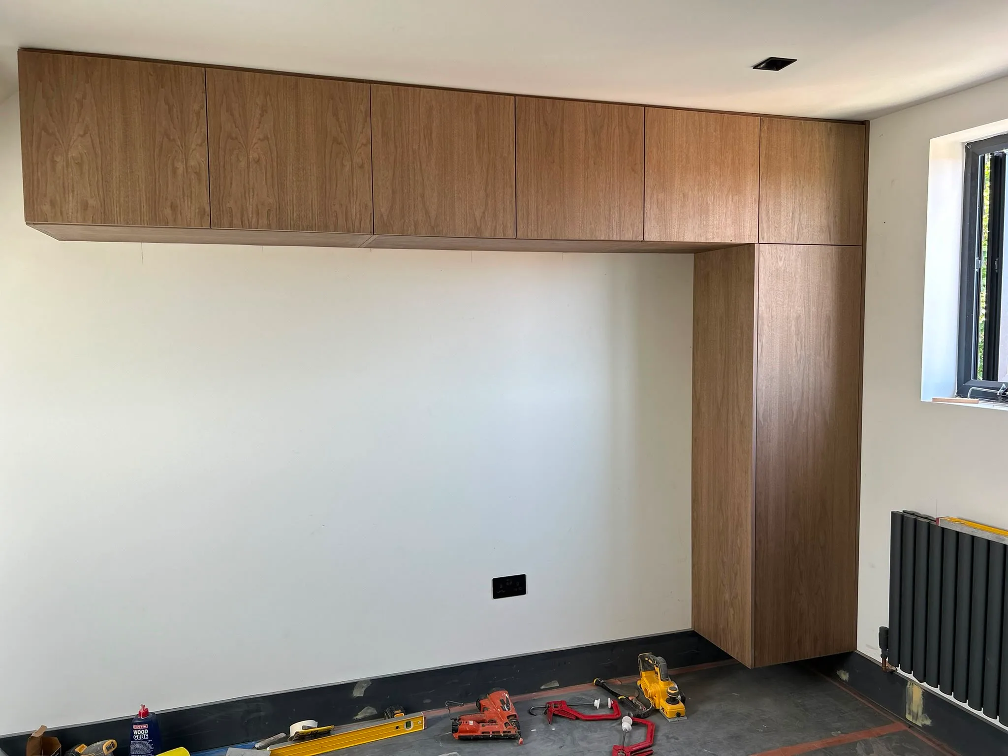 Modern wooden built-in wardrobe installation in a minimalist room