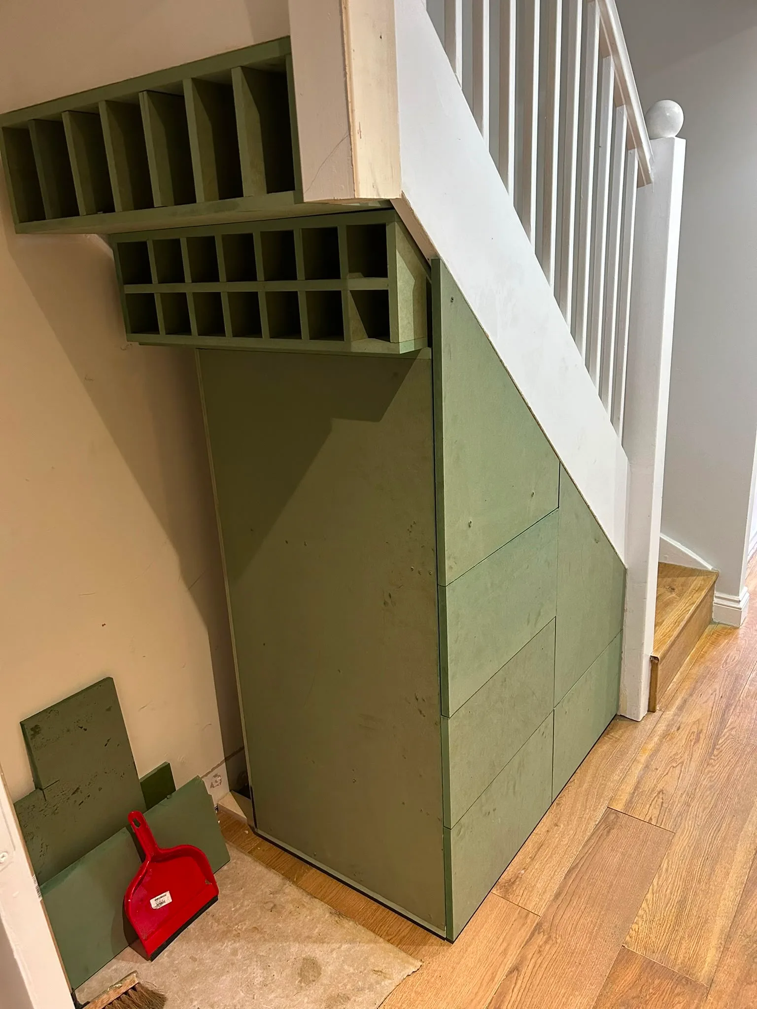 Custom built storage under the stairs with a minimalist design