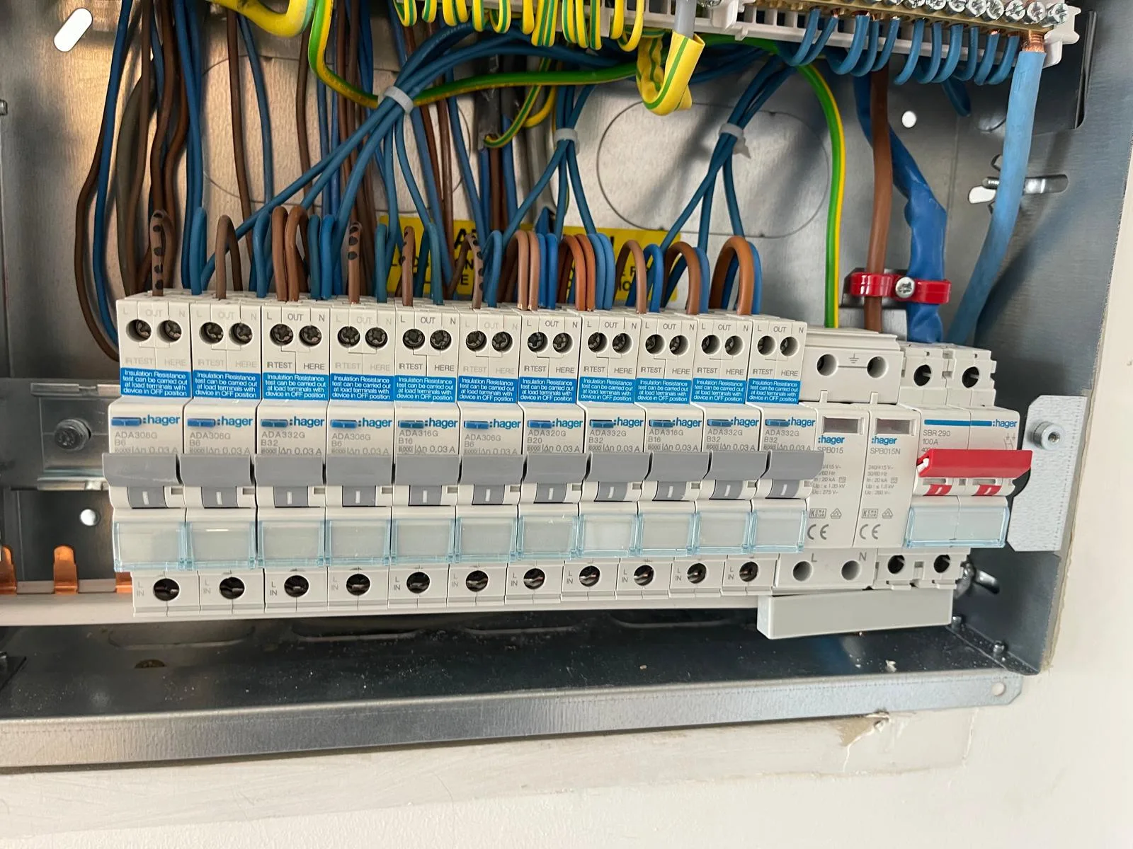 Close-up of a domestic electrical panel with circuit breakers and wiring connections