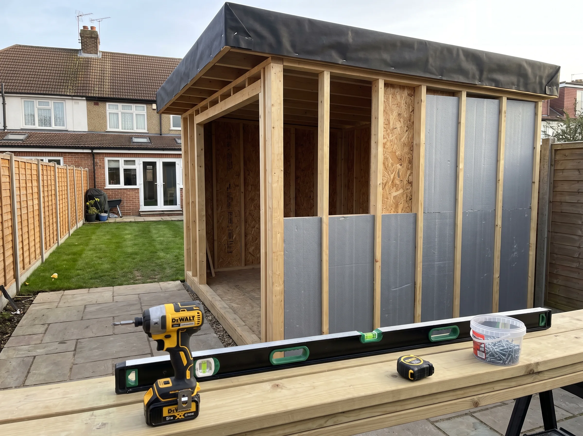 Construction of a garden outbuilding with tools and materials in view