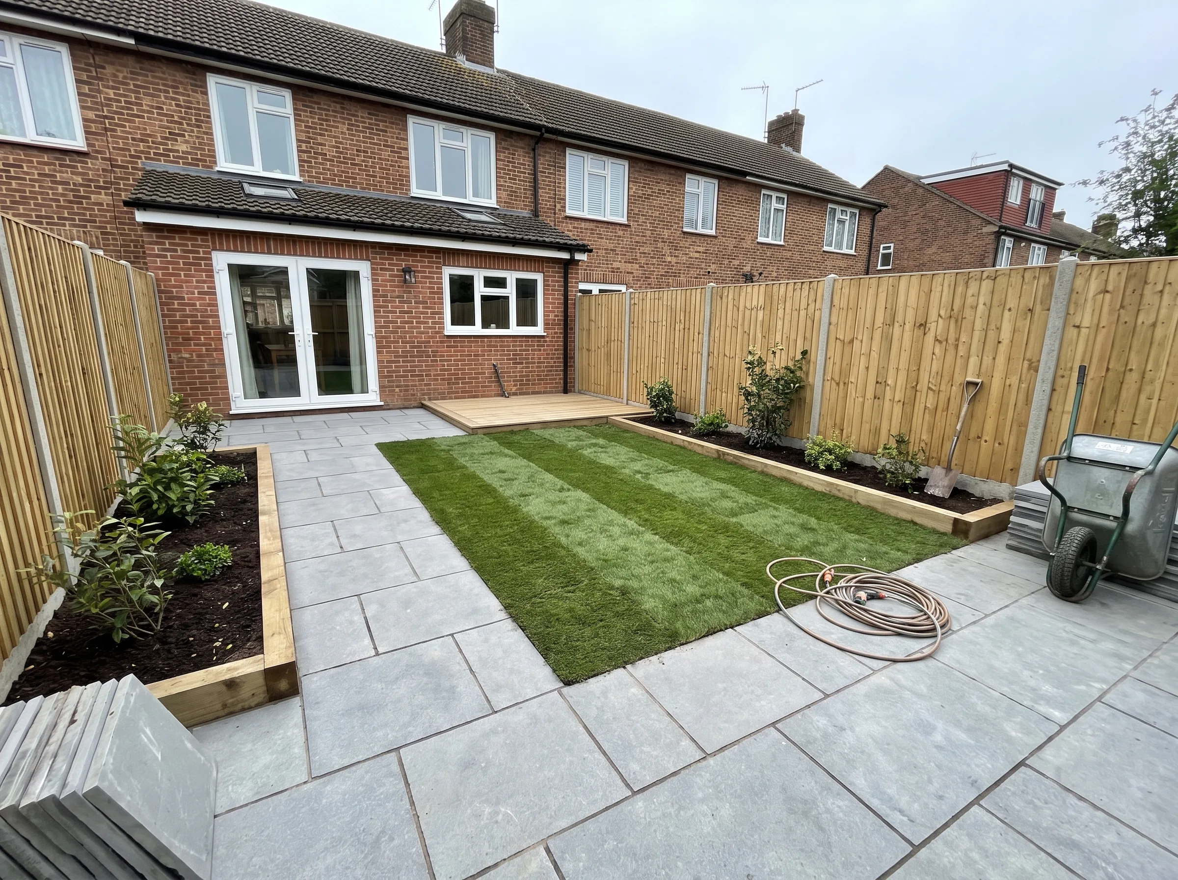 Newly landscaped garden with fresh turf and stone paving