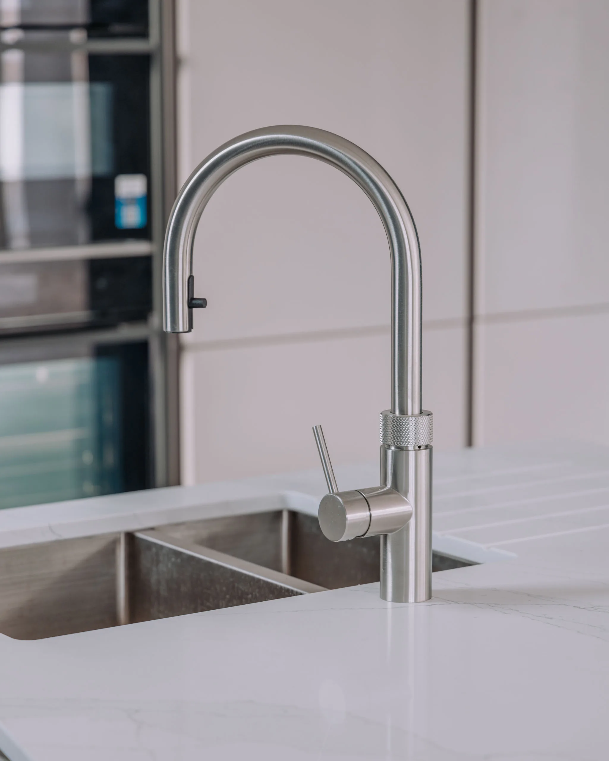 Modern kitchen faucet with sleek design above stainless steel sink