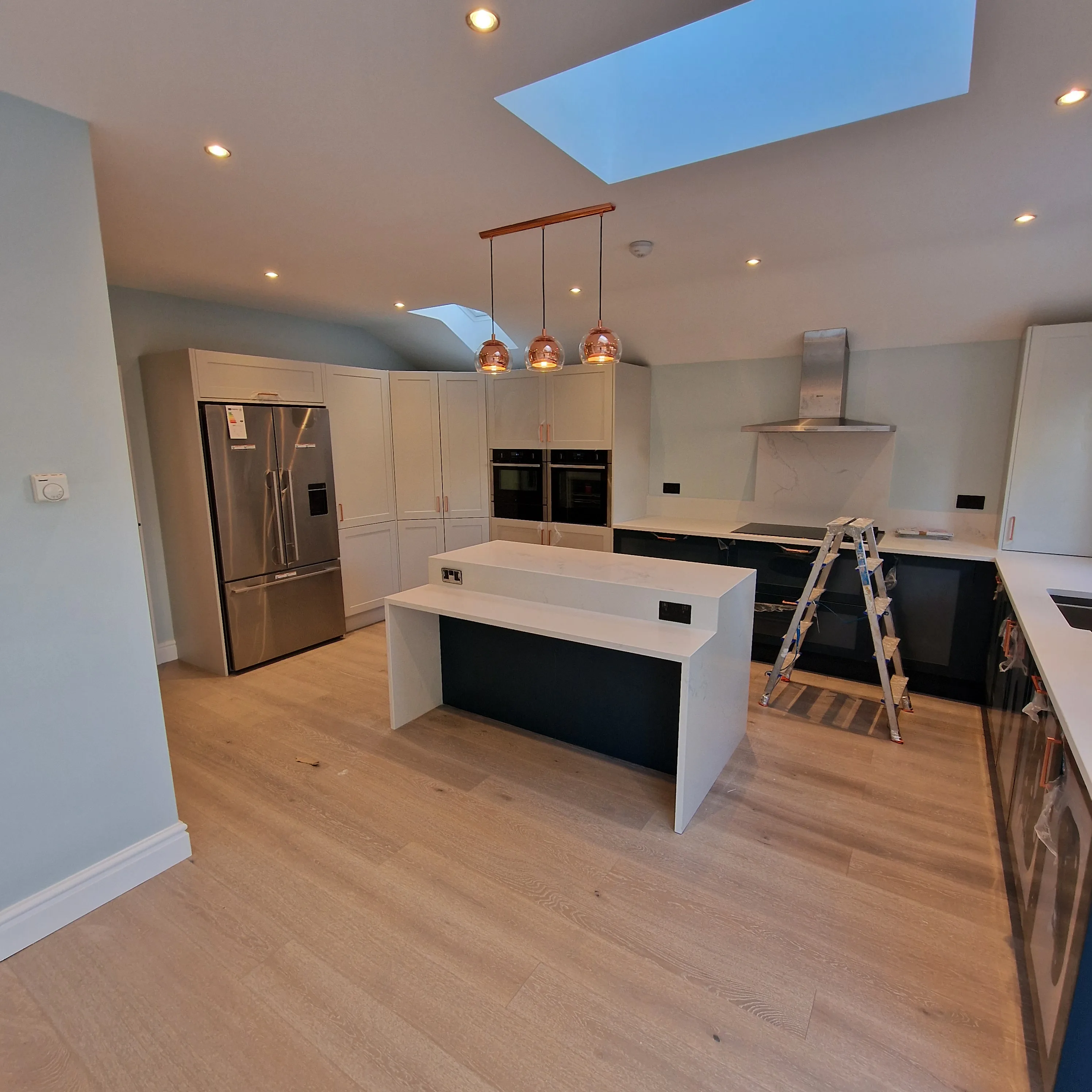 Modern kitchen refurbishment featuring sleek cabinetry and bright lighting