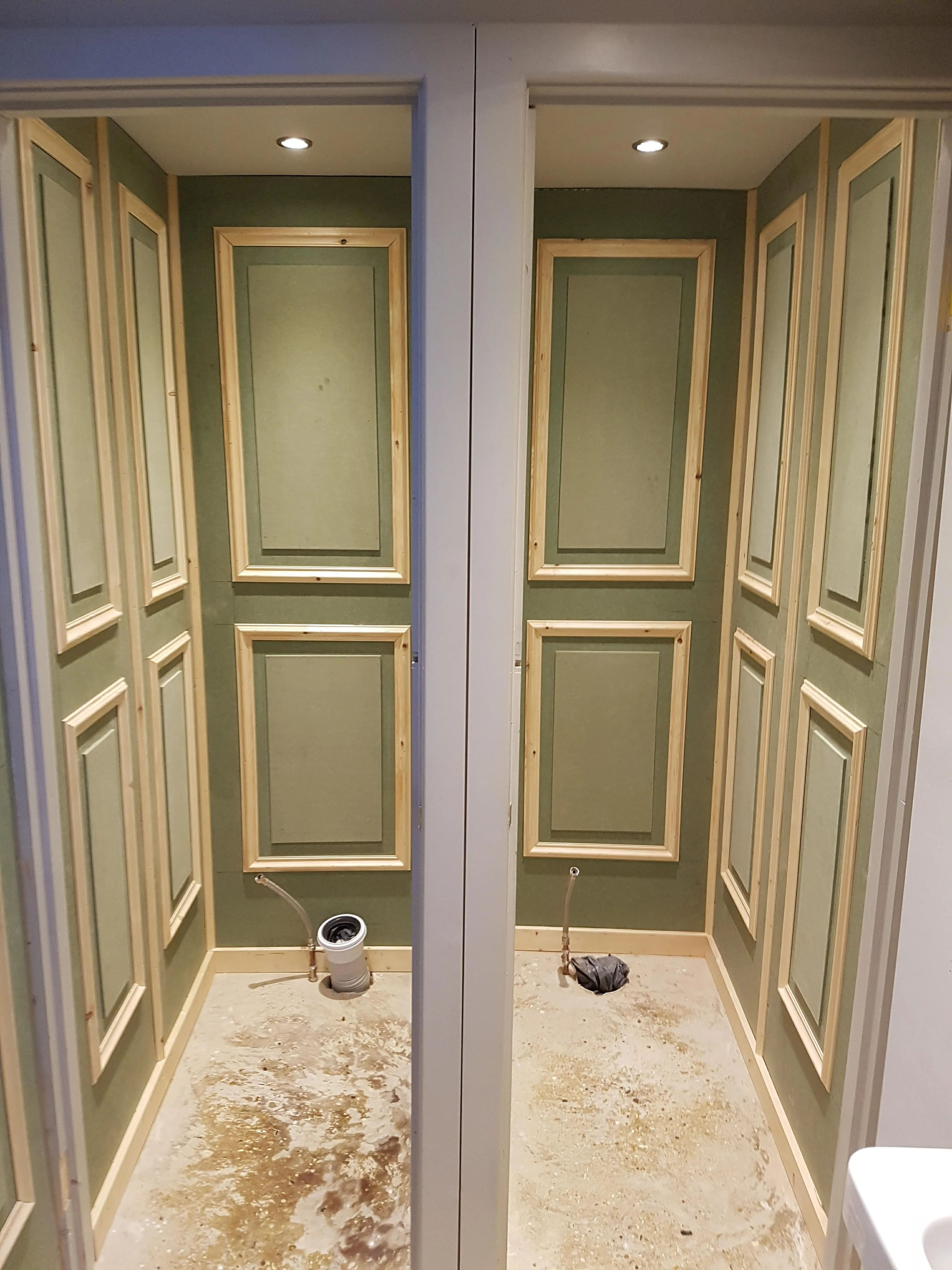 Interior view of a partially renovated bathroom with framed wall panels