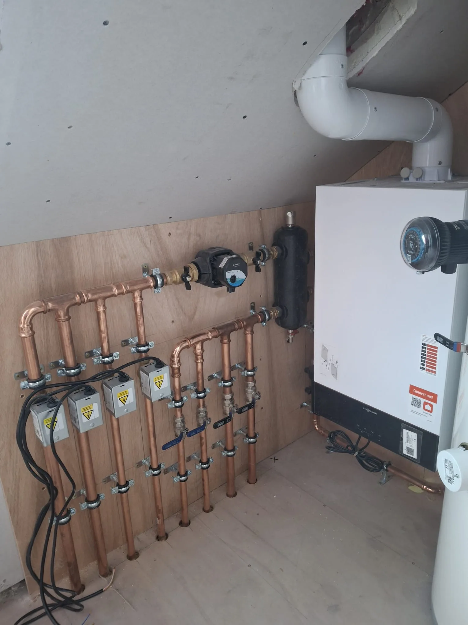 Close-up of newly installed plumbing and heating system in a loft renovation