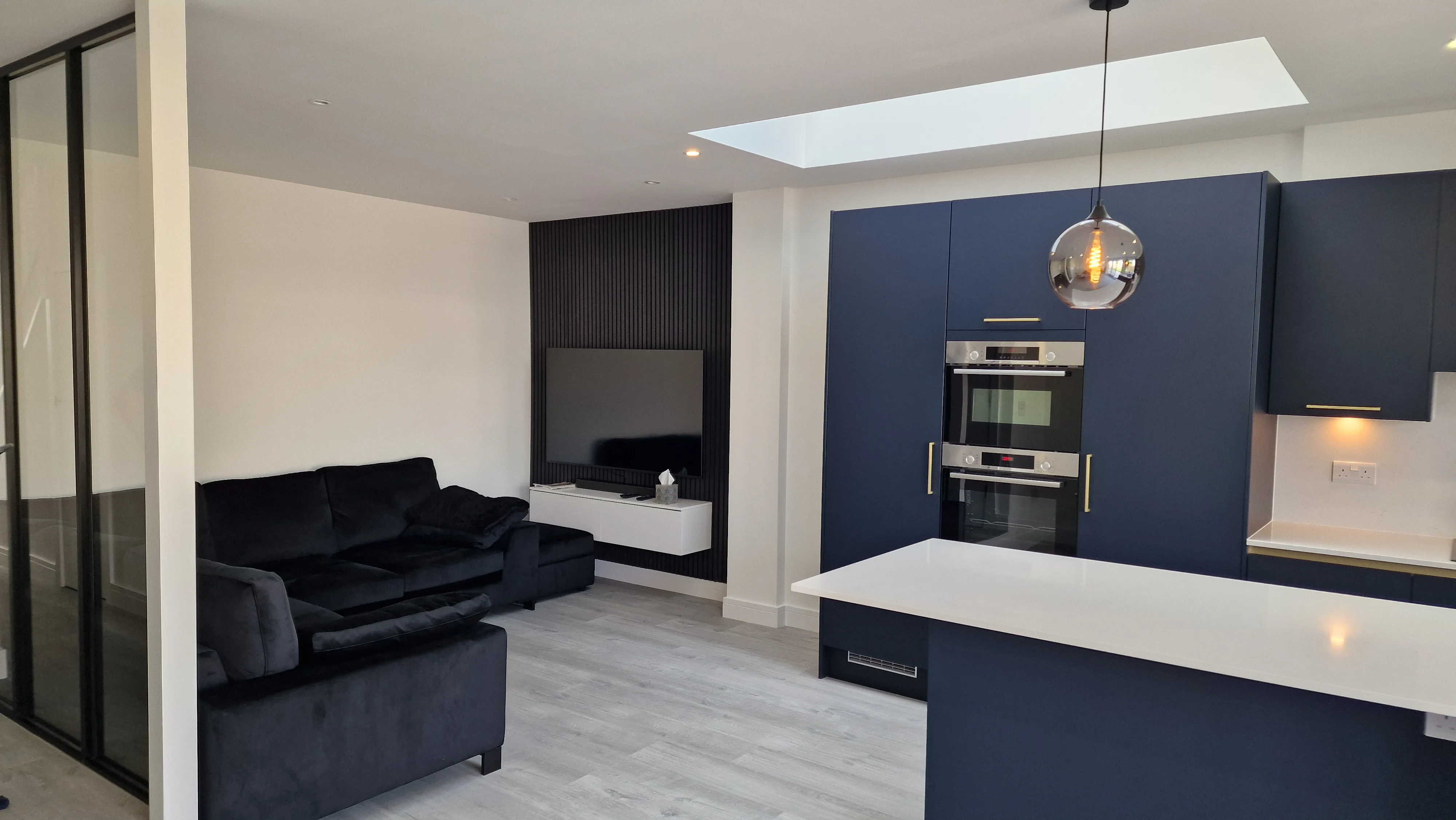 Modern kitchen refurbishment featuring sleek cabinets and open living space