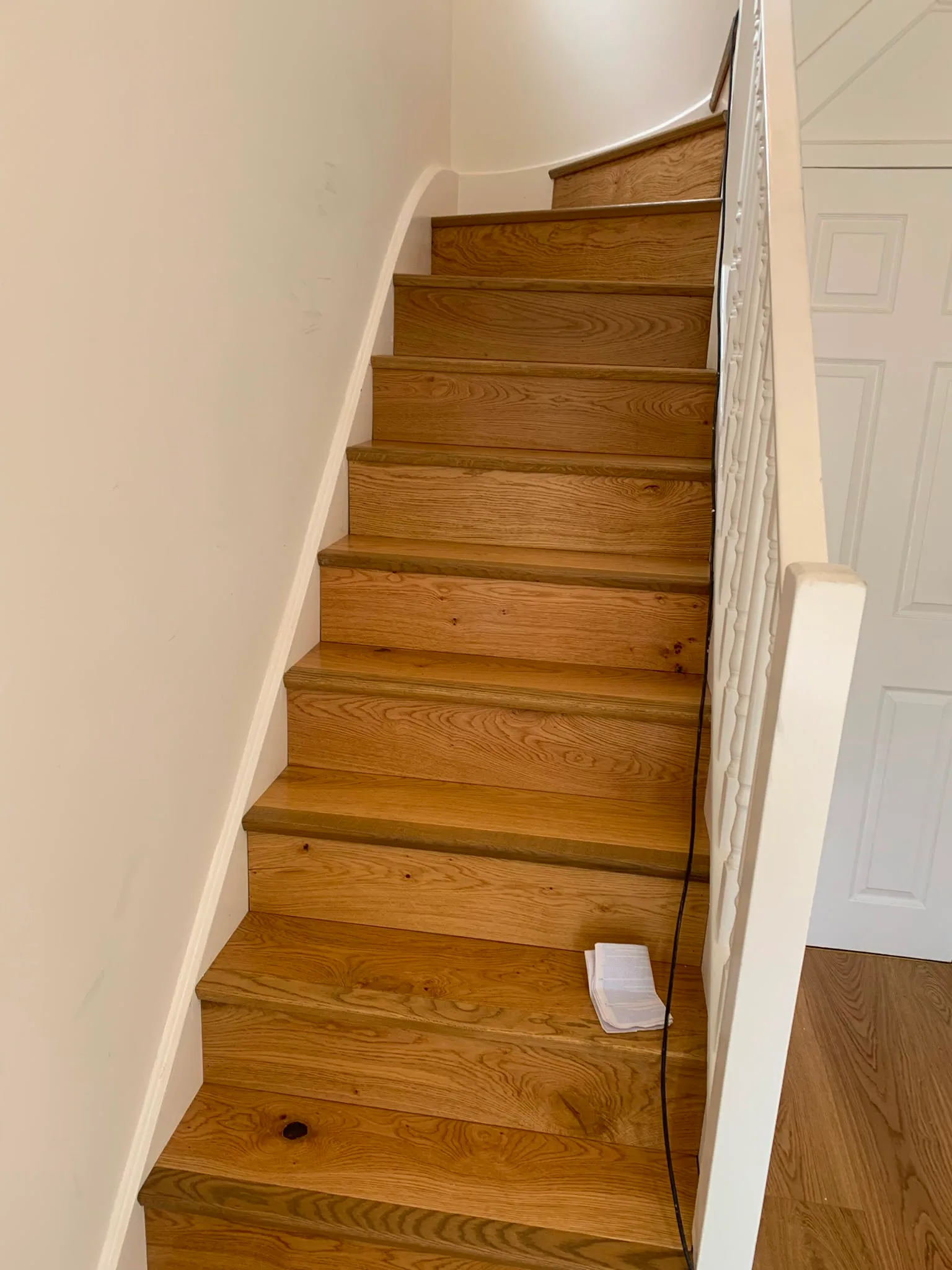 A wooden staircase with natural light, showcasing quality craftsmanship in home renovation